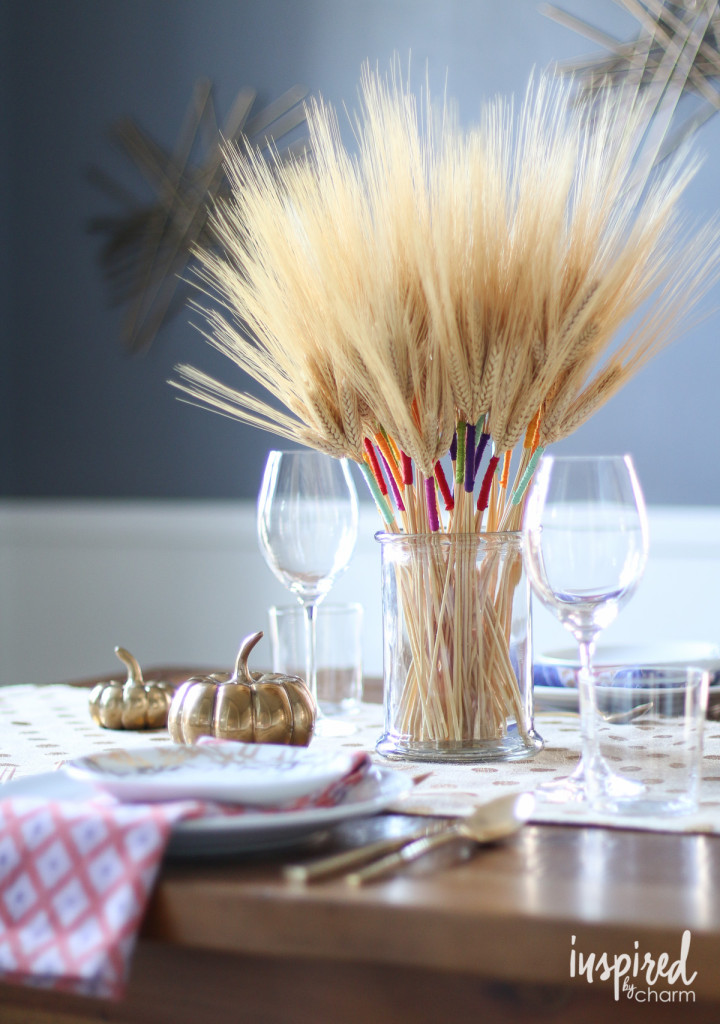 wheat thanksgiving centerpiece accented with wraps of colored embroidery floss