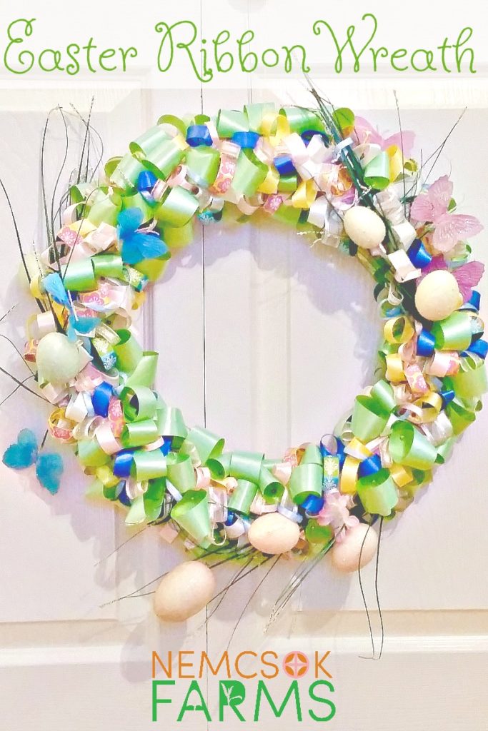 Easter ribbon wreath hung on a white door.