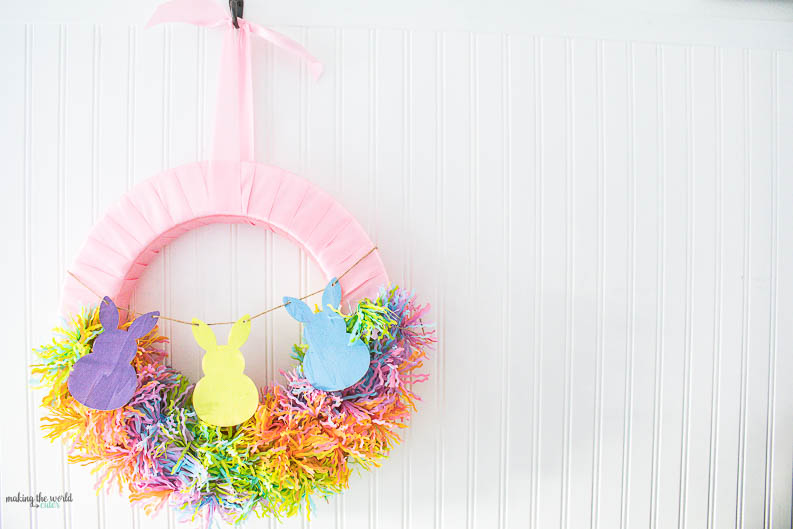 Pin easter wreath with bunny bunting and rainbow fringe wrapping.