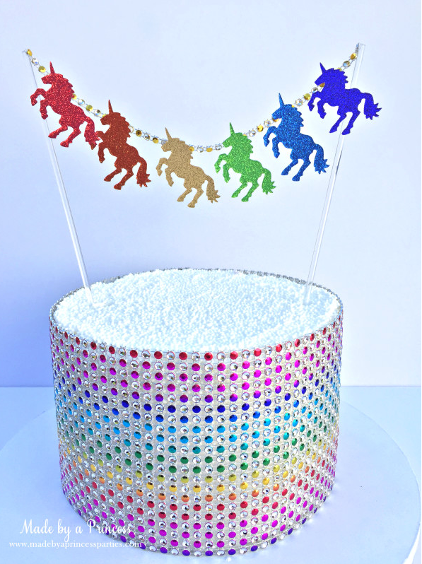 Rainbow unicorn garland cake bunting over an artificial cake